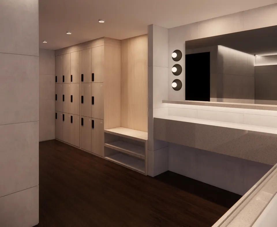Changing room with pale timber lockers and a stone vanity