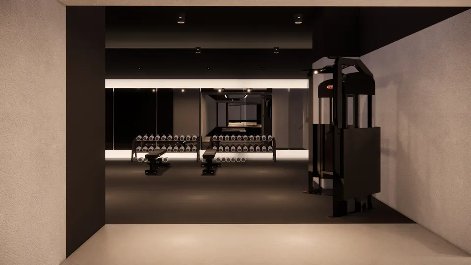 Weights room with dumbbell racks in front of a mirrored wall