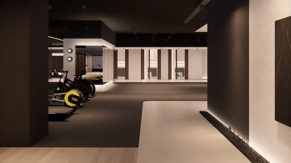 Cardio machines on a dark floor, looking across to the treatment room doors