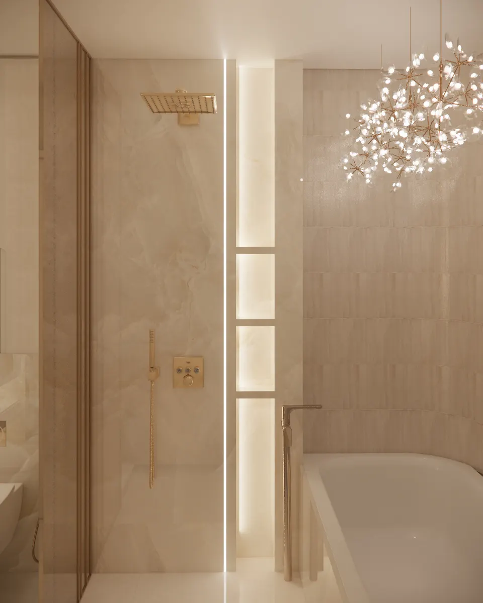 Shower and bath beneath a branching chandelier