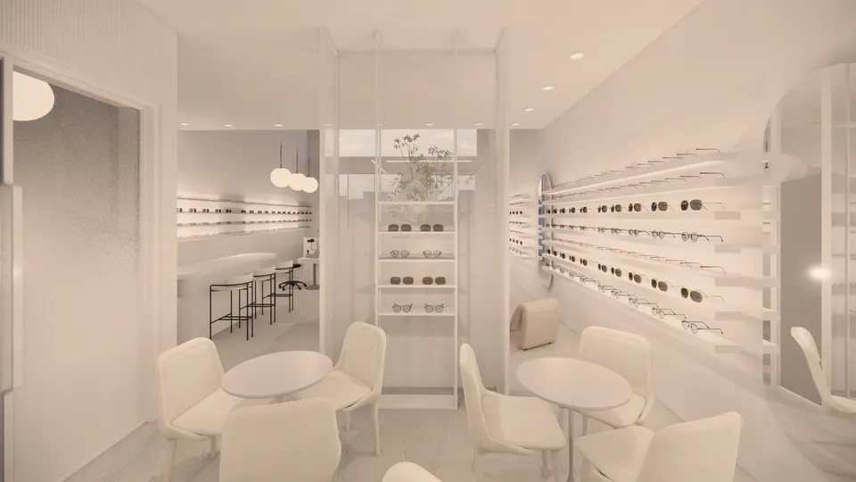 Round consultation tables beside a glass screen and a wall of frames