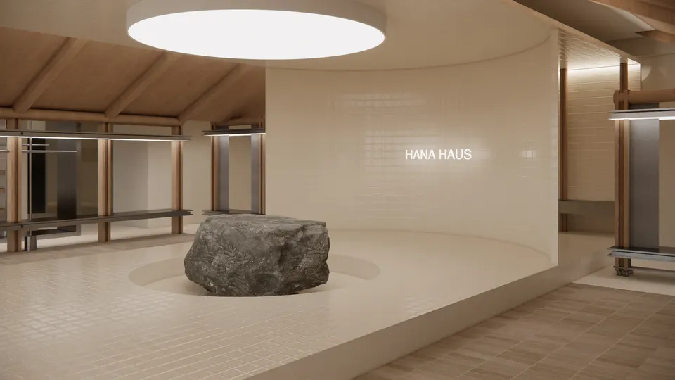 Boulder set into a round recess in a tiled platform, in front of a curved tiled wall