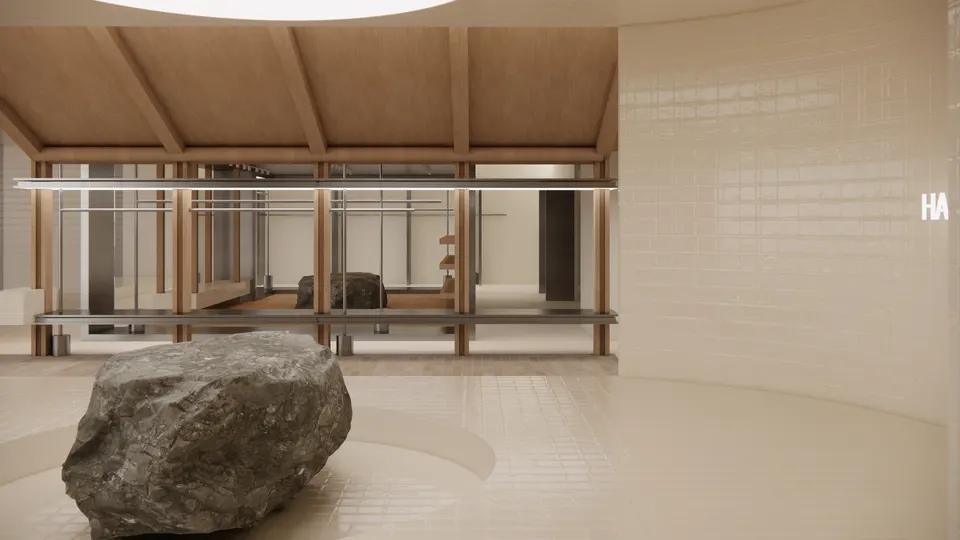 Boulder in the foreground with timber display frames under a pitched ceiling