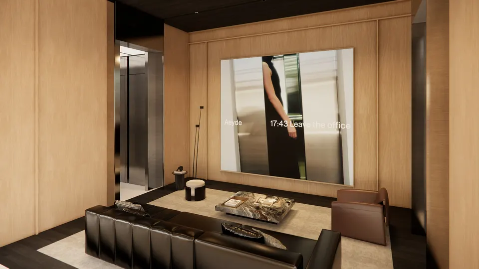 Lounge seen at an angle, with a stone coffee table and a tan armchair