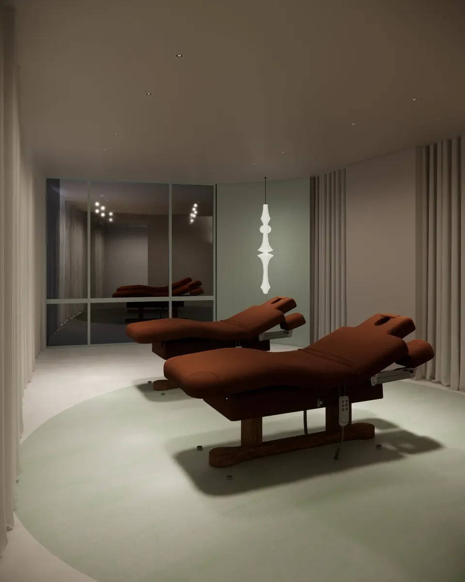 Two rust-coloured treatment beds in a curtained room with a sage floor