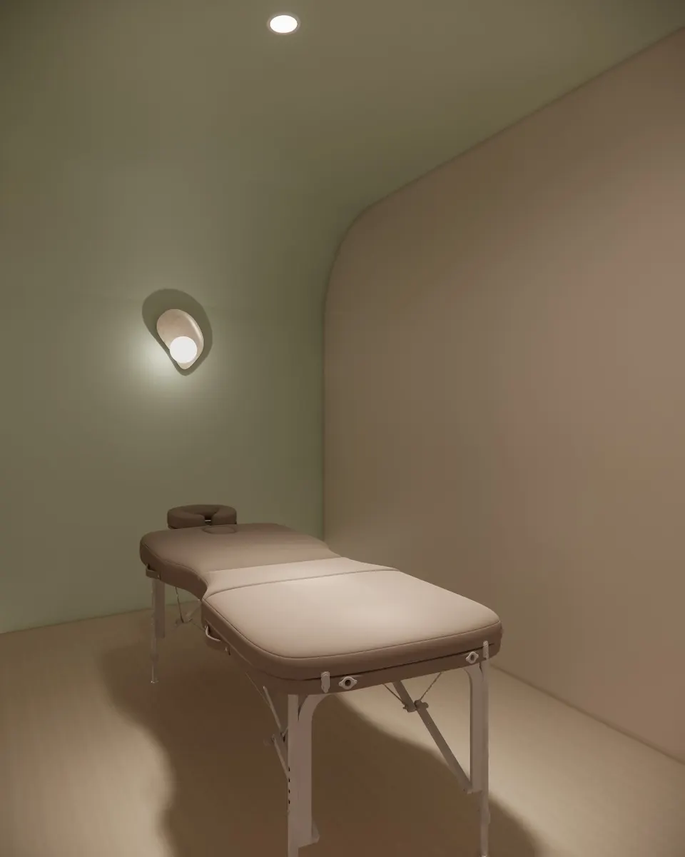 Single treatment bed beneath a round wall light