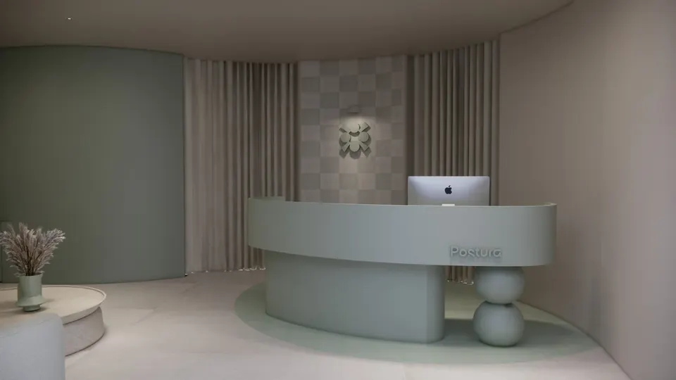 Curved sage reception desk in front of curtains and a chequered wall panel