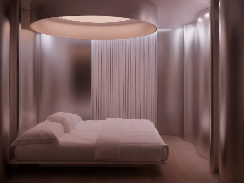 Bedroom setting with a low bed under a round ceiling light, enclosed by curved metal walls