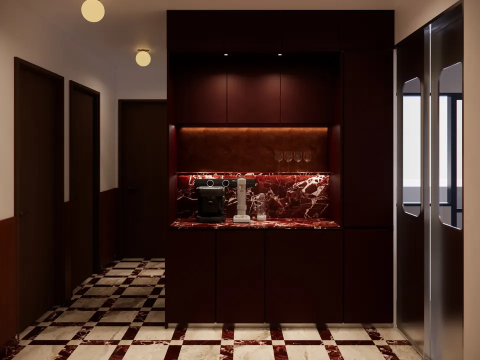 Coffee bar with a red marble counter set into dark cabinetry