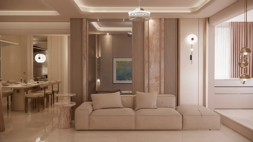 Living room with a cream sofa, blush stone wall panels and the dining table beyond