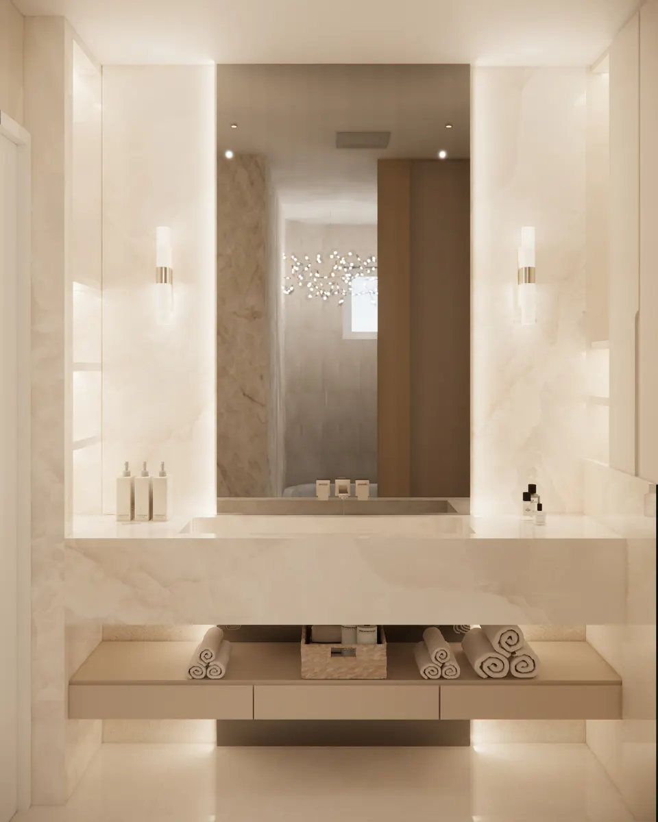 Backlit cream stone vanity with a tall mirror