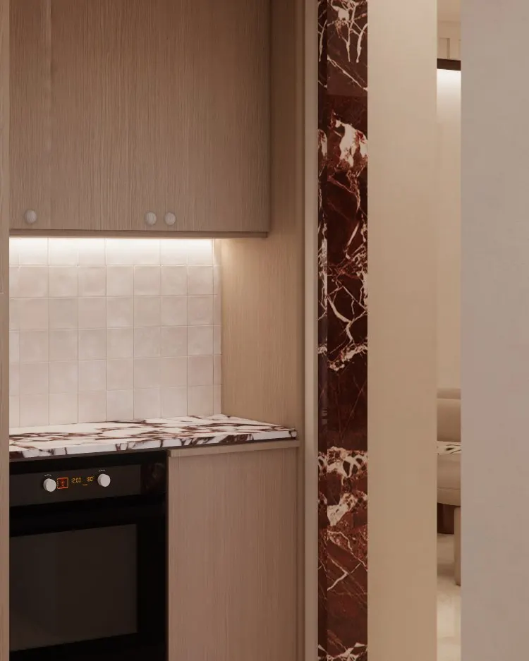 Built-in oven below a tiled niche, beside a red marble door frame