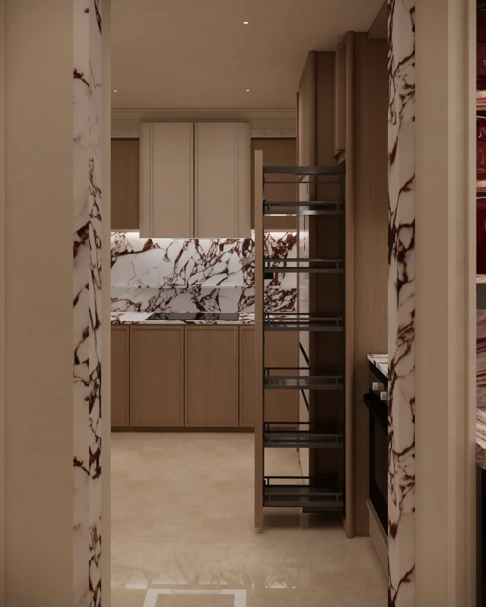 Kitchen seen through a marble-framed doorway with a pull-out larder
