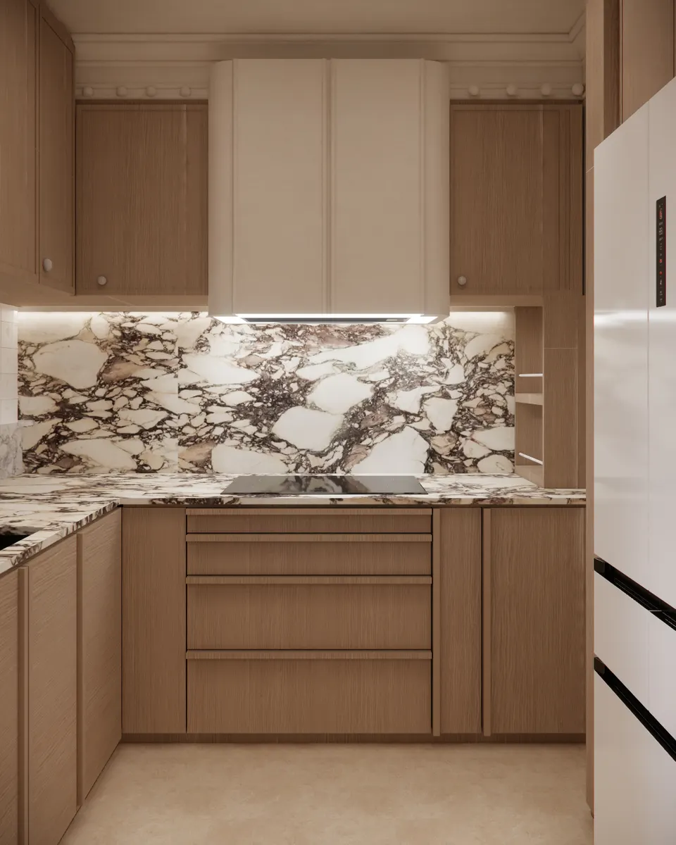 Kitchen hob wall with a veined marble splashback and a curved cream hood