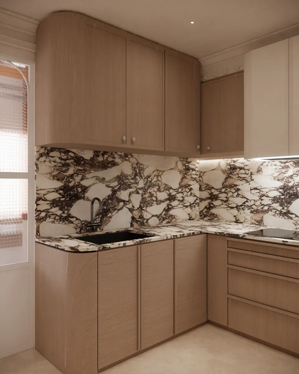 Kitchen corner with a black sink set into veined marble