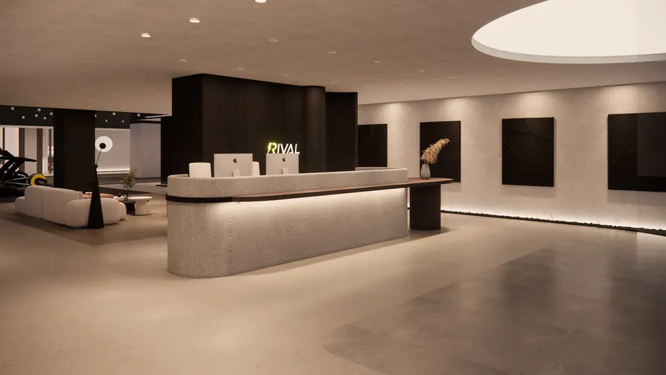 Reception desk seen from the side, with the lounge beyond
